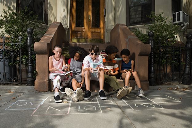 Kids sitting on New York City stoop